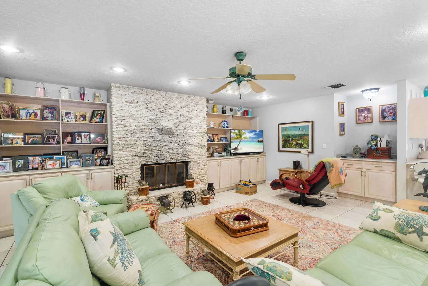 Family room with wood burning coral fireplace.