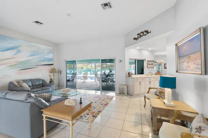 Living room. Walk out to screened patio, pool, and lake.