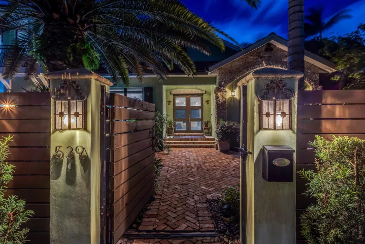 Beautifully landscaped, gated courtyard leading to a stunning front entry.