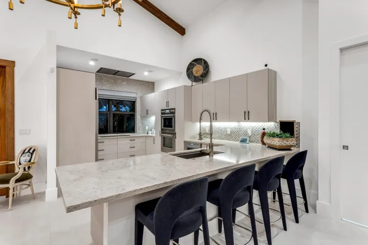 Spacious gourmet kitchen with peninsula seating for four and sleek modern finishes.