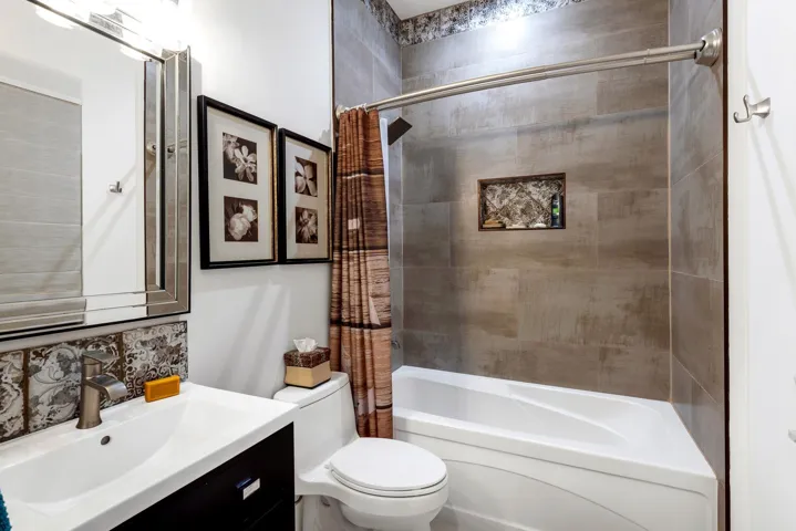 Stylish bathroom with designer tile and tub-shower combo.