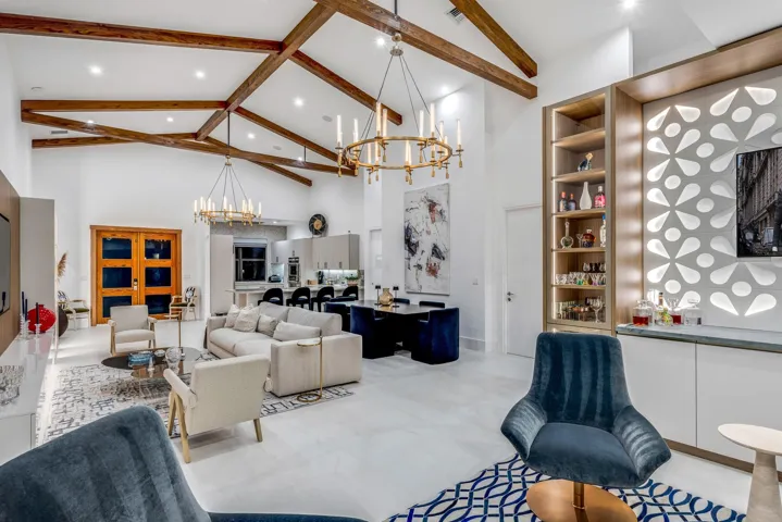 Soaring vaulted ceilings with exposed beams and designer chandeliers.