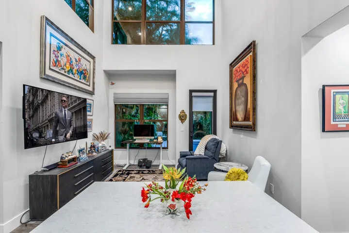 Open living space with double-height ceilings and tranquil garden views.