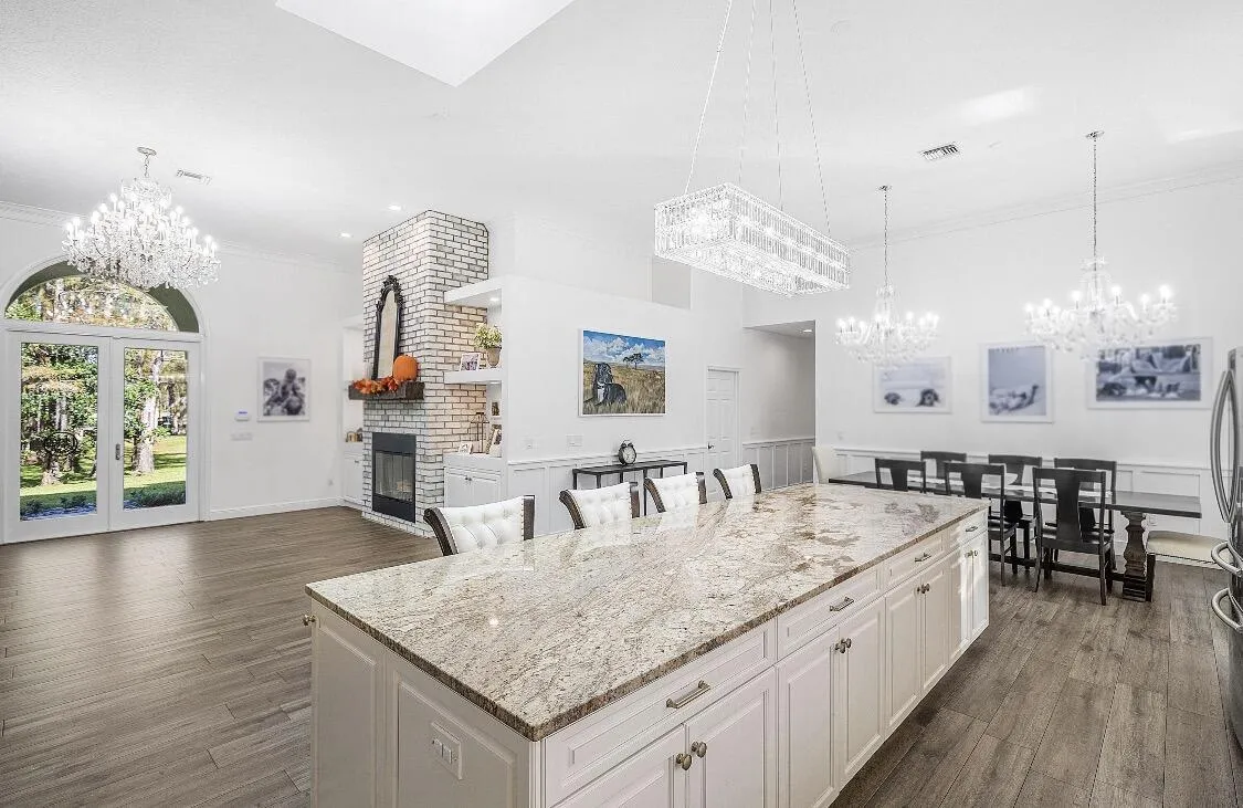 Cool island, formal dining overlooks golf course with a lake view.
