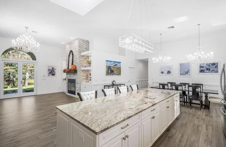 Cool island, formal dining overlooks golf course with a lake view.