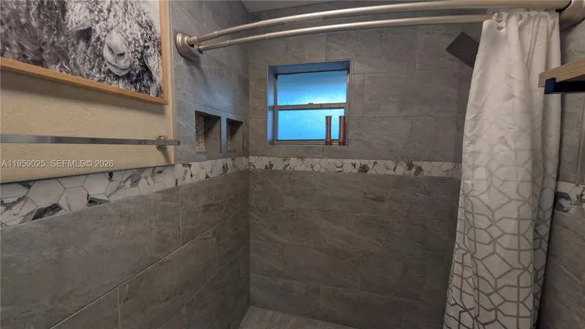 bathroom nicely decorated with tile all through out