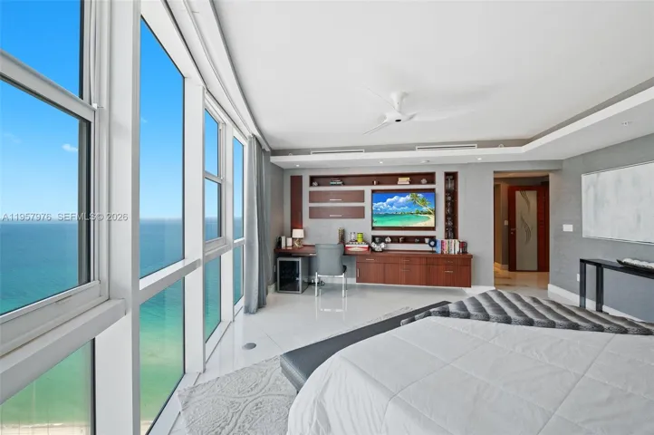 Primary suite with private seating area and workspace.