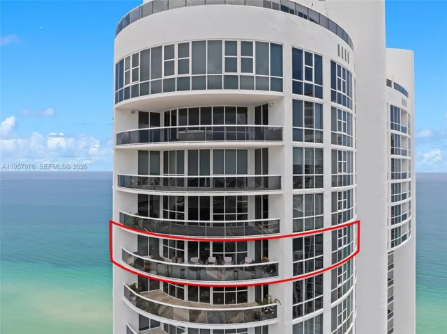 Aerial view highlighting this high-floor beachfront residence.