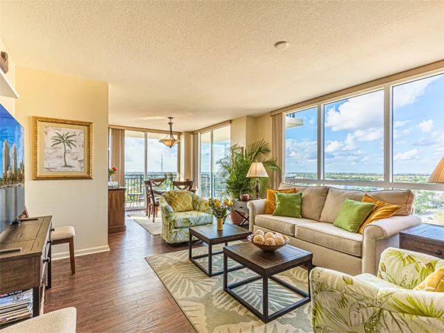 Bright, open living and dining areas feature wood flooring, floor-to-ceiling glass, and sweeping New River, downtown, and city skyline views.