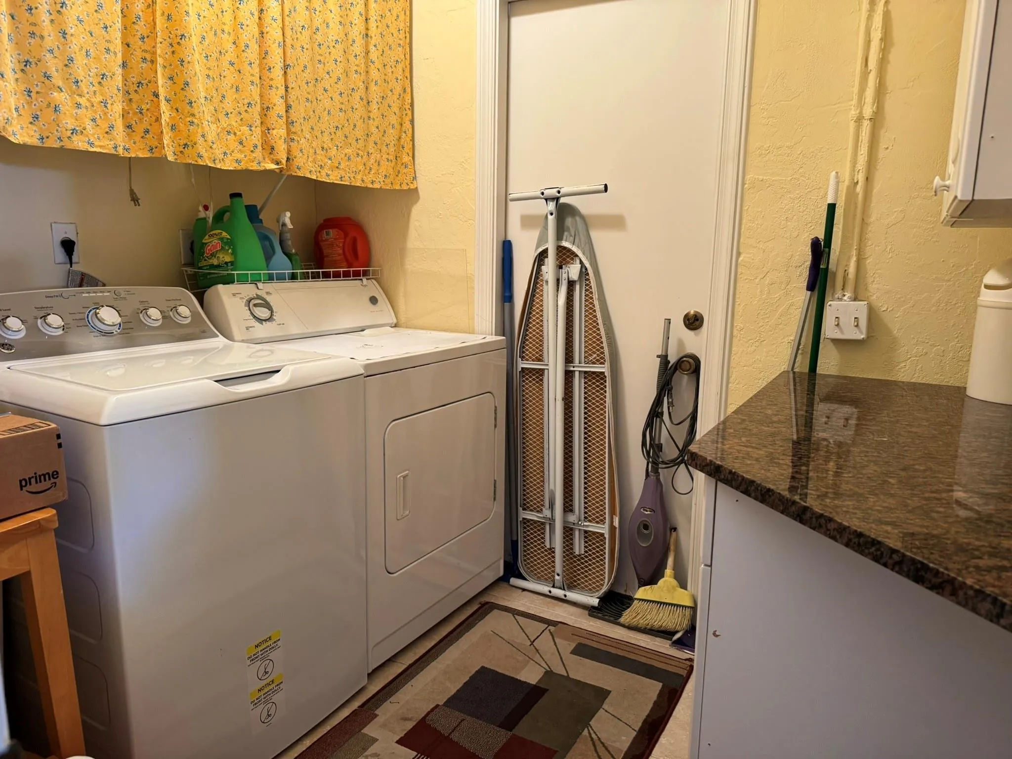 Laundry with Granite top folding area and cabinetry