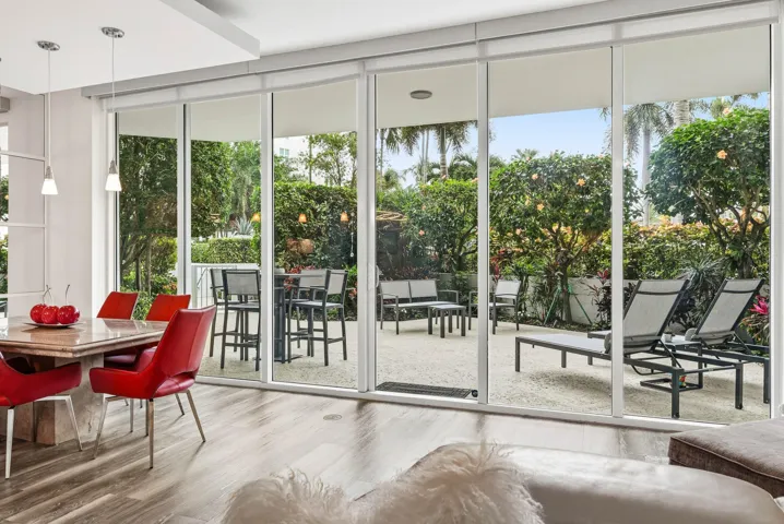 Floor-to-ceiling impact-resistant sliding glass doors lead to your private garden