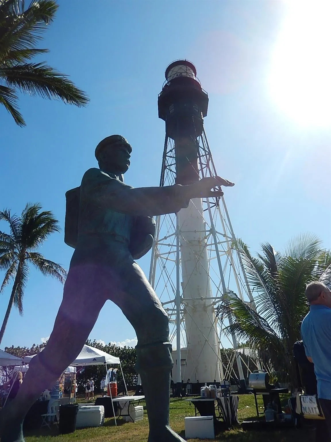 Legendary Barefoot Mailman statue in the shadow of the Hillsboro Lighthouse