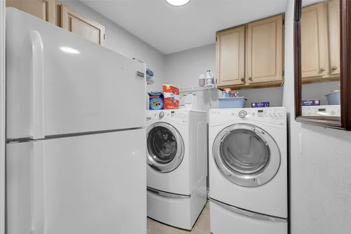 Laundry area with washing machine and dryer and cabinet space, 2nd refrigerator, easy access to garage