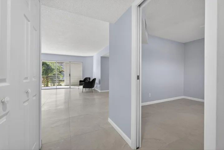 View of guest bedroom and living area from entry door