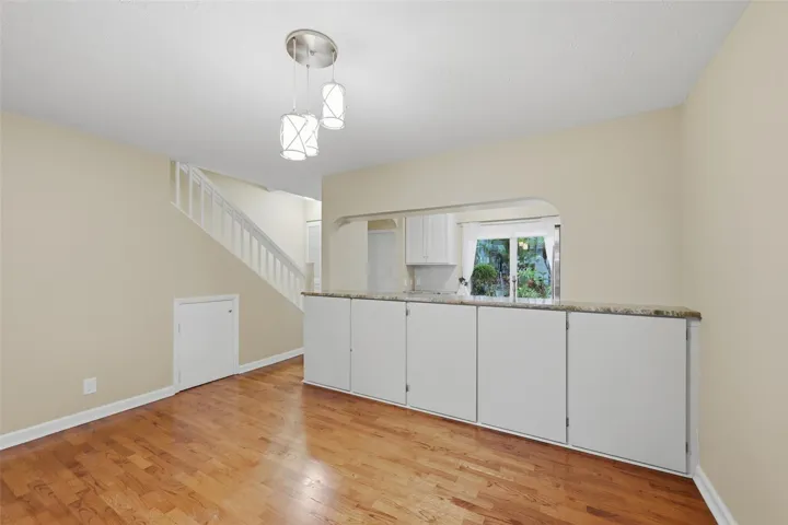 The dining area flows seamlessly into the kitchen while offering additional storage for everyday convenience and organization.