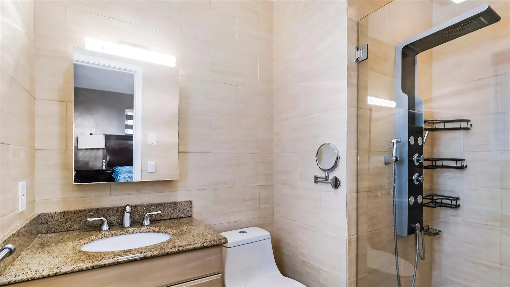2nd Bathroom beautifully updated with neutral tiles, new vanity and glass enclosed shower with rain shower head and massage jets.
