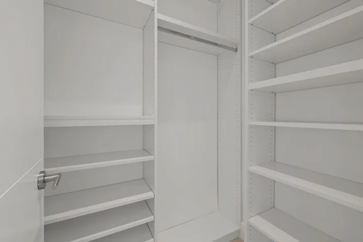 walking closet with custom built in cabinetry