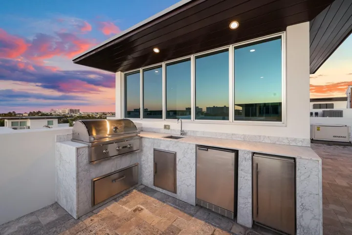 Gorgeous like new stainless steel summer kitchen with natural gas grill, small fridge and ice maker
