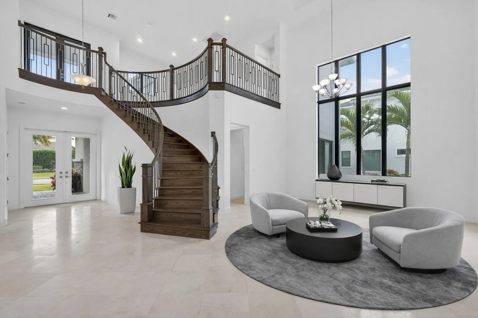 Modern foyer with curved staircase and s