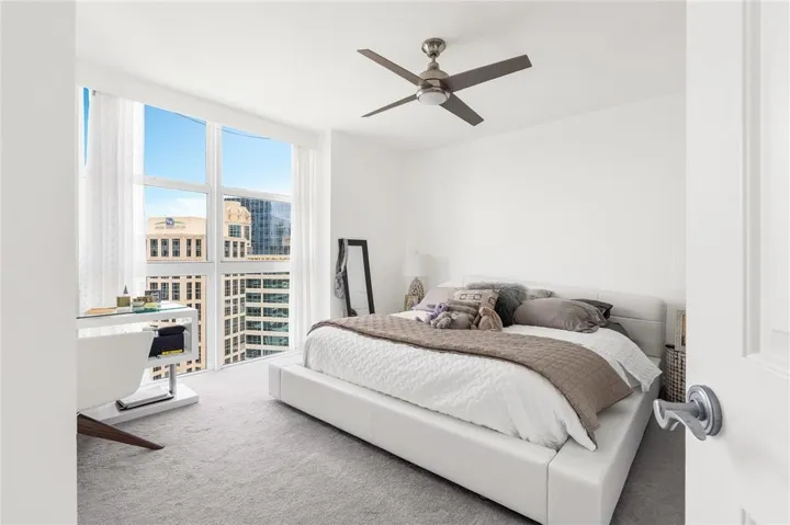 Spacious Primary Suite with floor to ceiling windows and desk - perfect for working at home