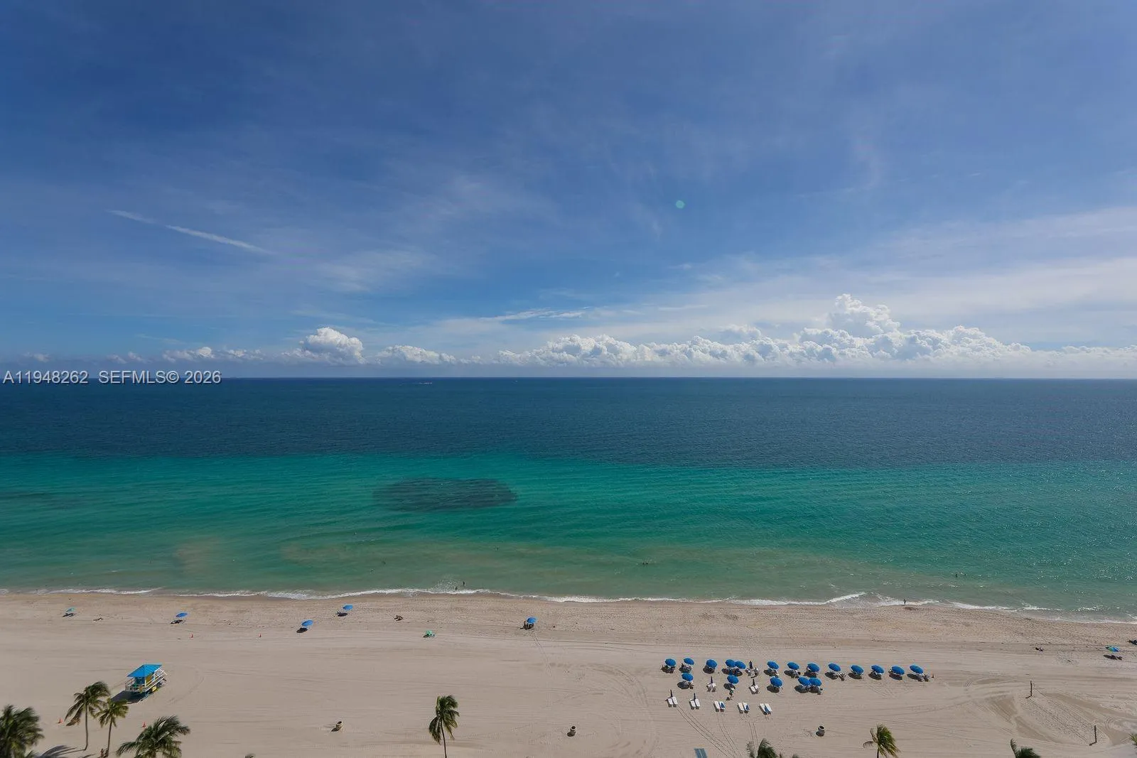 your beach -sand with courtesy beach umbrella service.look at the colors of the beach sand water