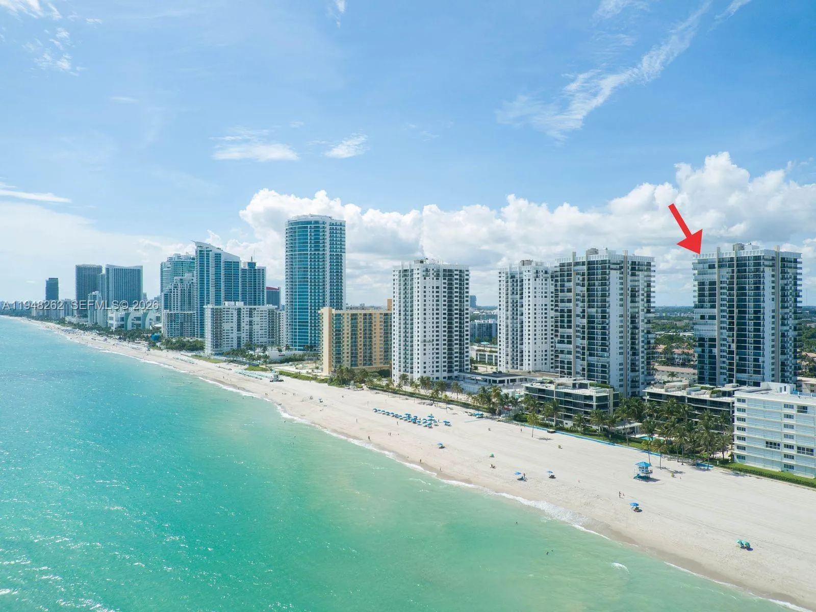 amazing wide and long beach ariel view of the complex