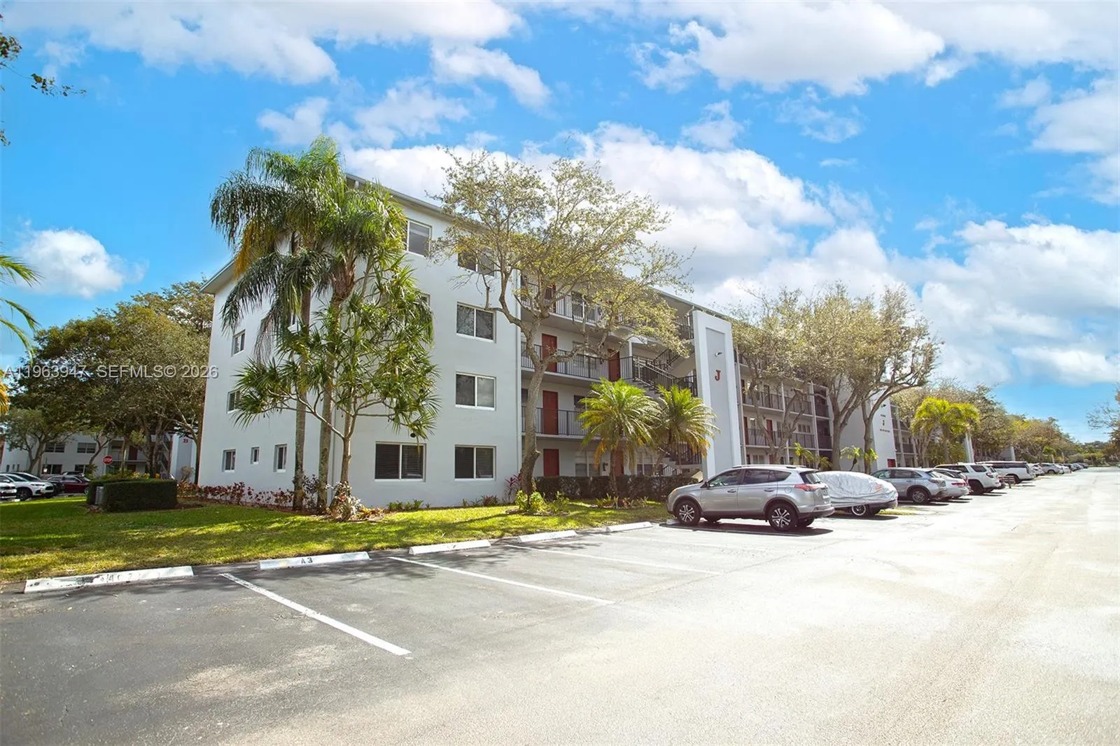 FRONT OF BUILDING AND SEVERAL GUEST PARKING