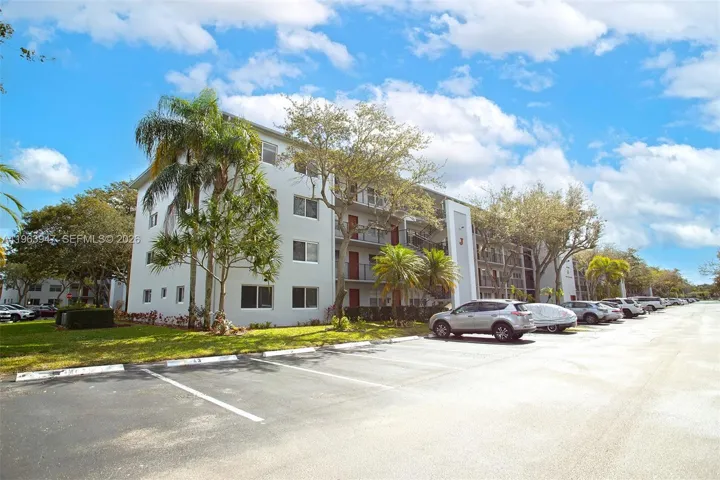 FRONT OF BUILDING AND SEVERAL GUEST PARKING