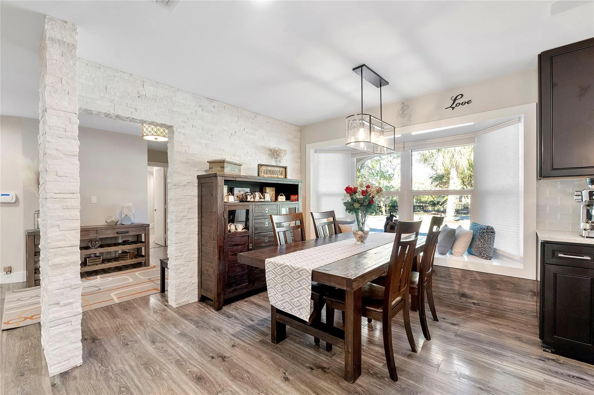 The main dining room that shares the open floor plan of the family room and kitchen, with such an exciting bay window with a window seat for 2, very romatic for a Valentines luncheon,