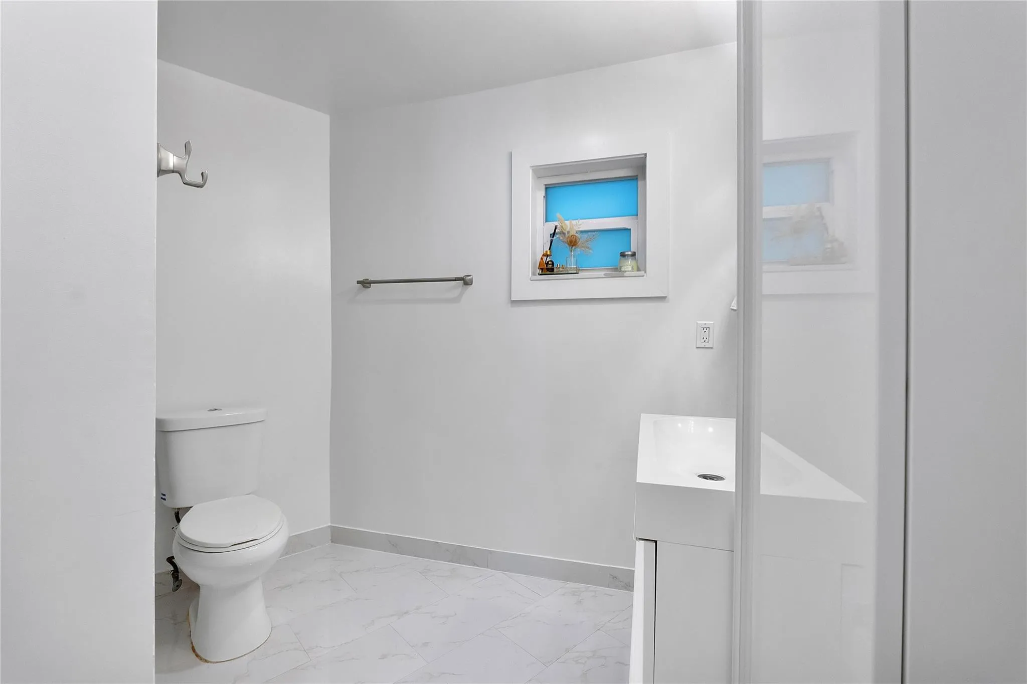 What a pretty bathroom ready for some towels on the towel holder and your robe hanging on the hook,