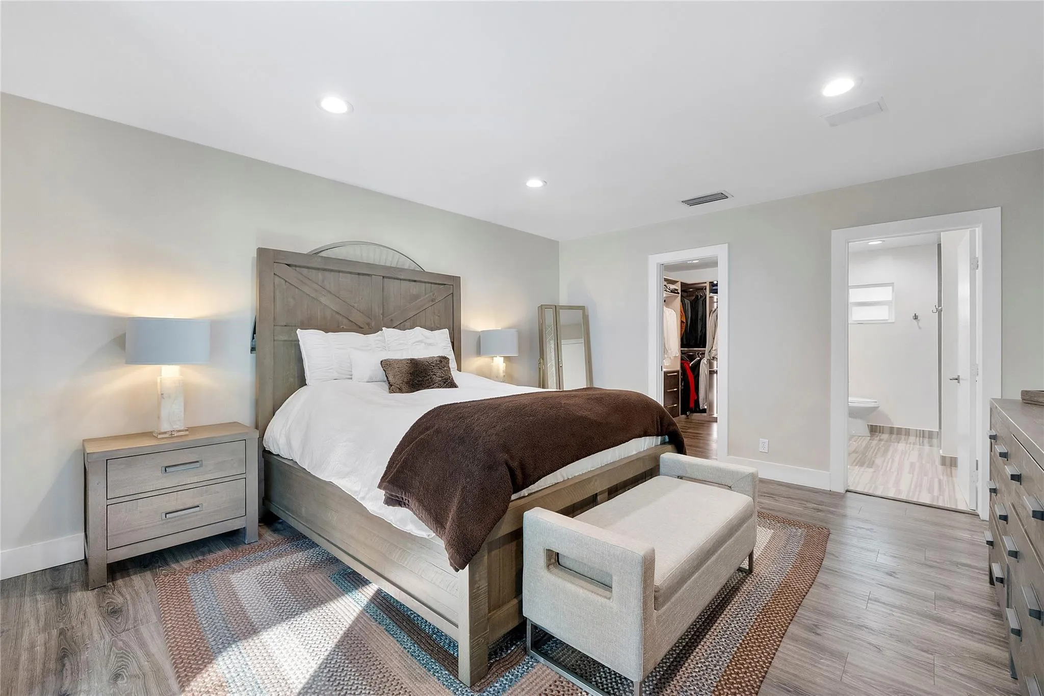 The Primary Master bedroom has a beautiful ray of sunshine coming through the windows and skylight,