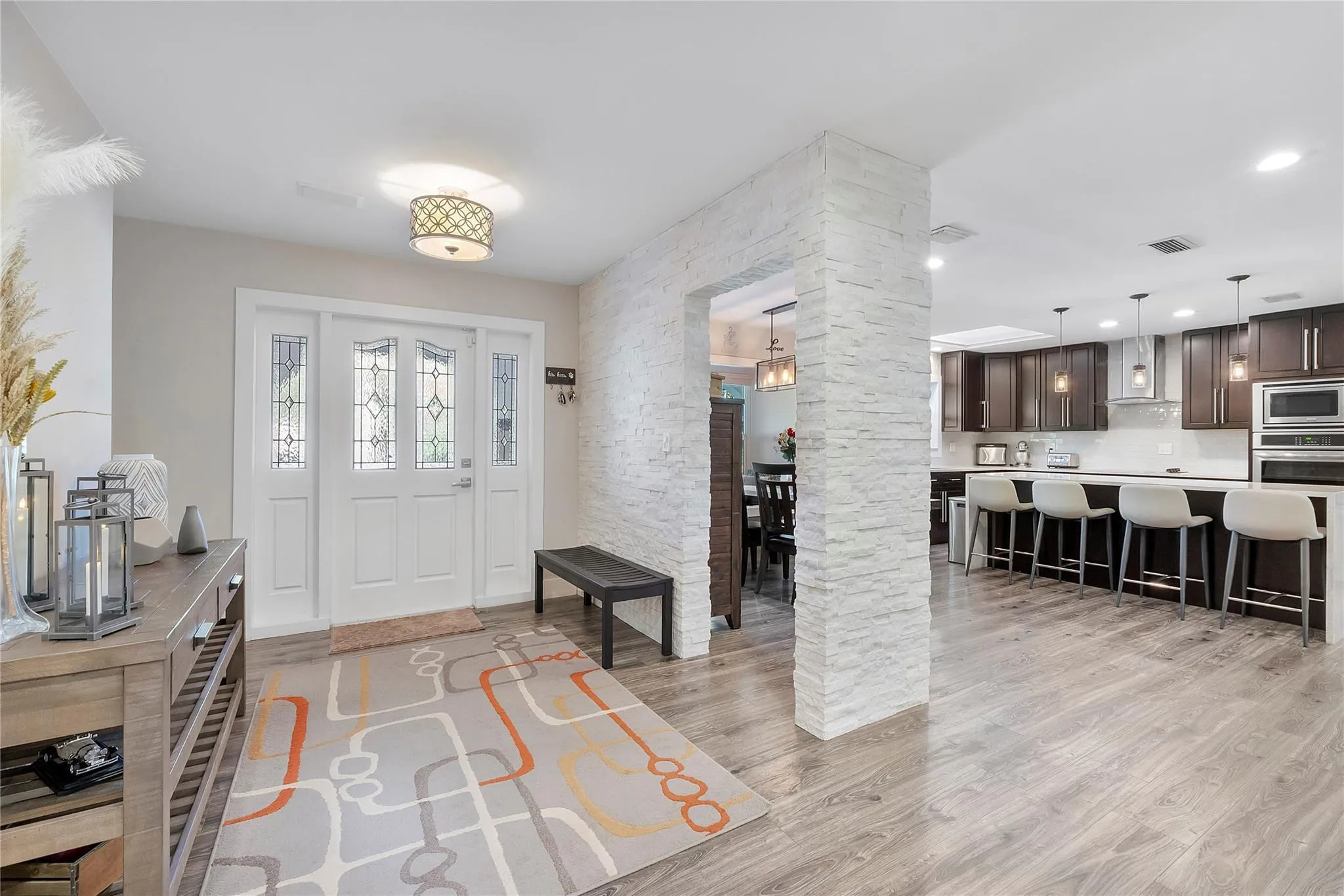 The stylish modern stone archway to your left as you walk in is part of accent walls and doorways throught the home