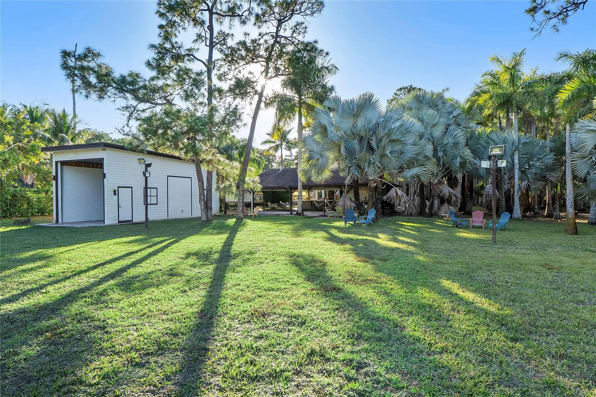 This is a view of the RV Hanger and the 1200 sq foot gazebo wooden deck Tiki-style great entertainment area that was originally built as a Barn for horses & can easily be renovated back to a barn or used as an arts & crafts meeting place or similar Parkland ladies get togethers or meeting or conferences, The gazebo is equipped with a real Pizza oven and BBQ Griller and juicers and lots of entertaining spaces and seats and tables, You could even hold Karaoke nights or have a band perform for your guests