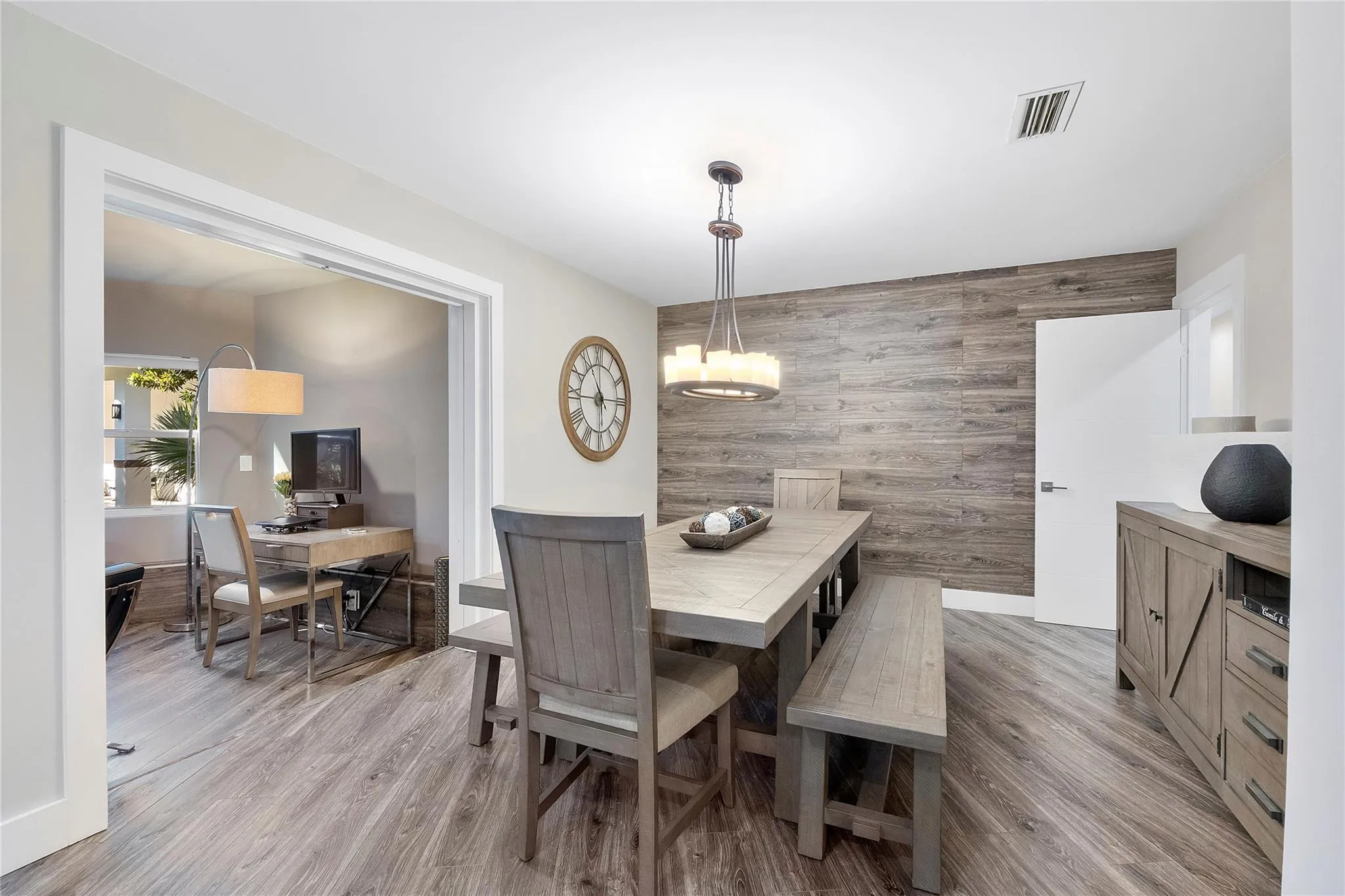 The Formal dining room opens up to the Piano sitting room or den,