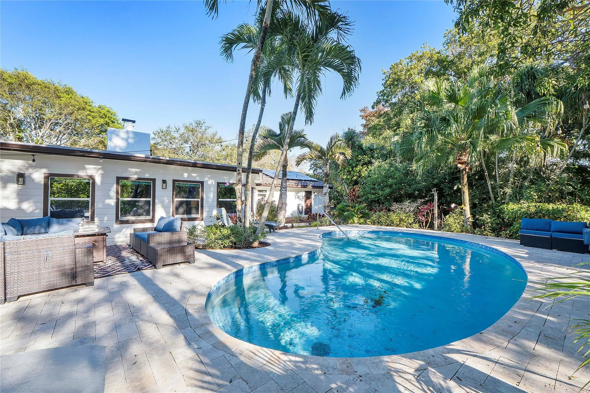 The pool is heated and surrounded by elegant pavers