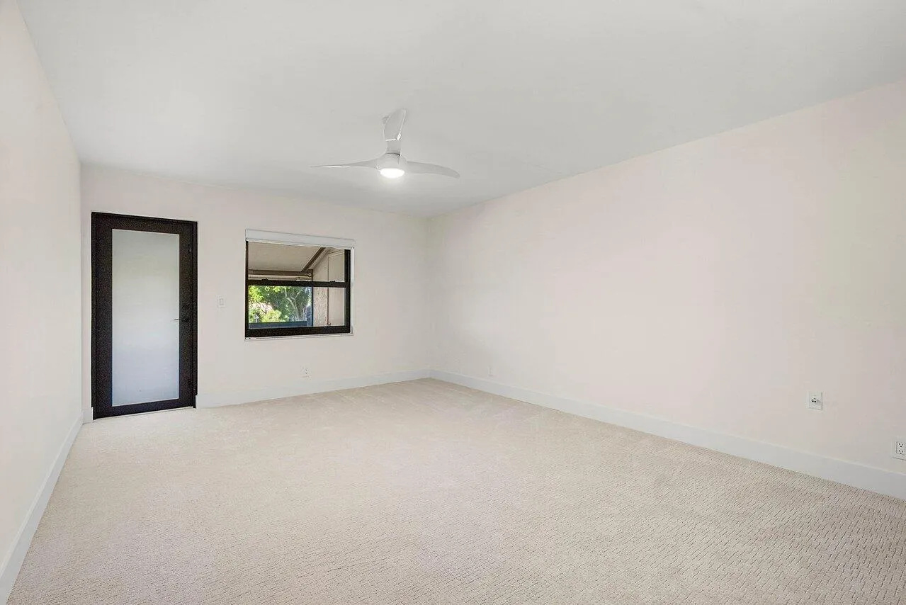 Primary bedroom with impact door to patio.