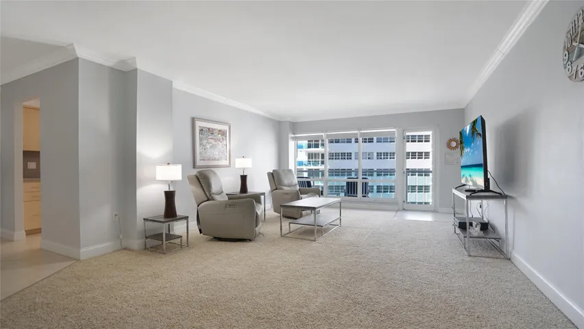 This apartment is spacious and bright. The door leads out to the balcony.