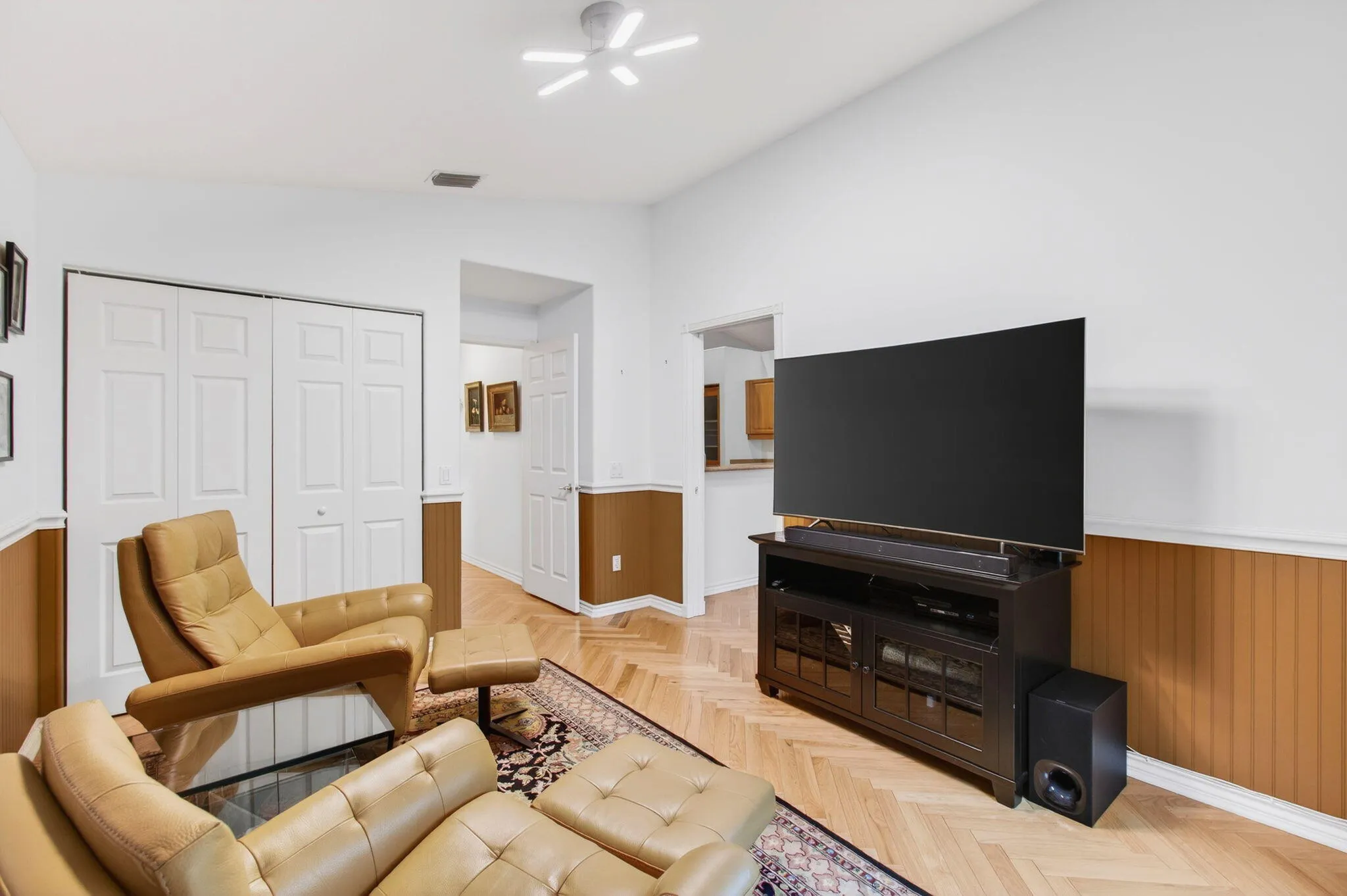 Currently set up as a den/TV room, a full closet enables it to serve as a bedroom