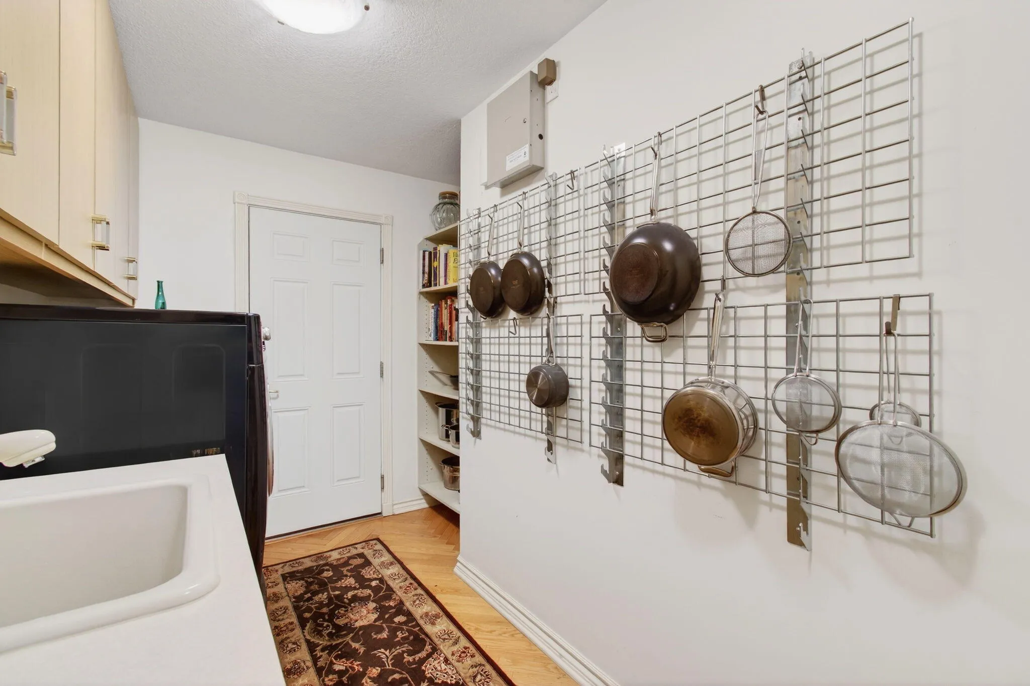 A cook book library and additional cookware have a place here