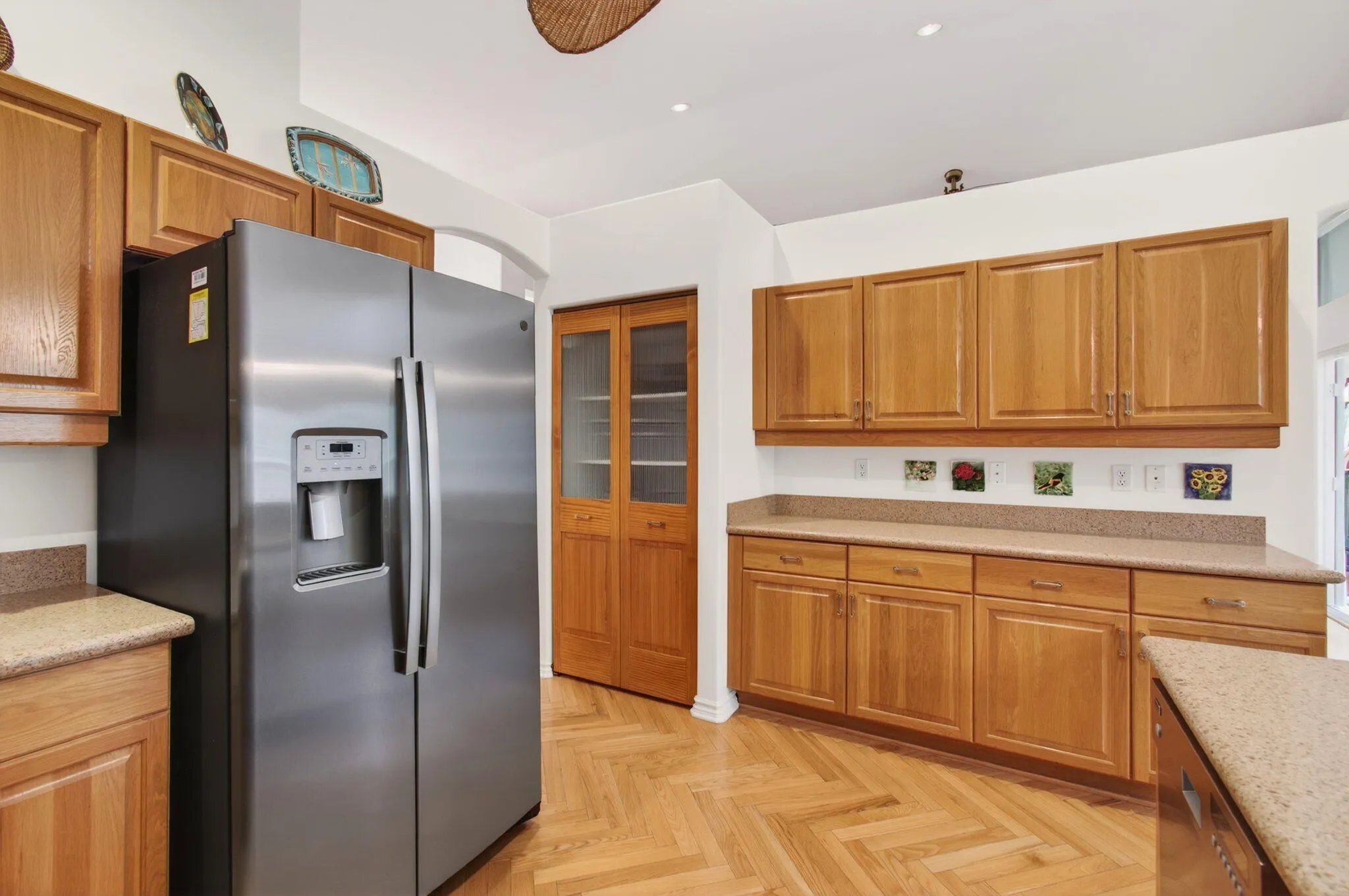 Large pantry next to ample cabinetry with large countertop for kitchen appliances