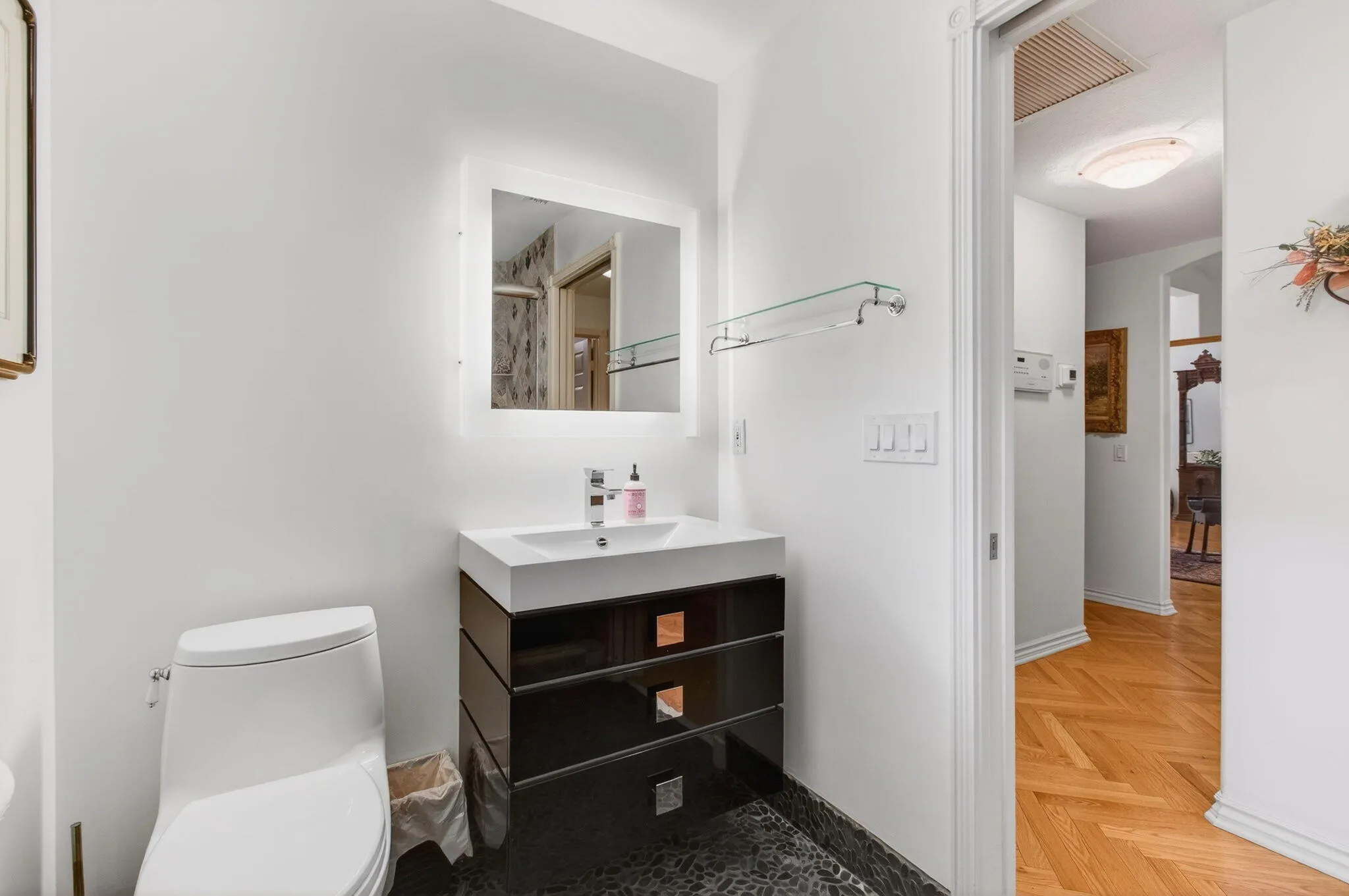 Low toilet, contemporary vanity, backlit mirror