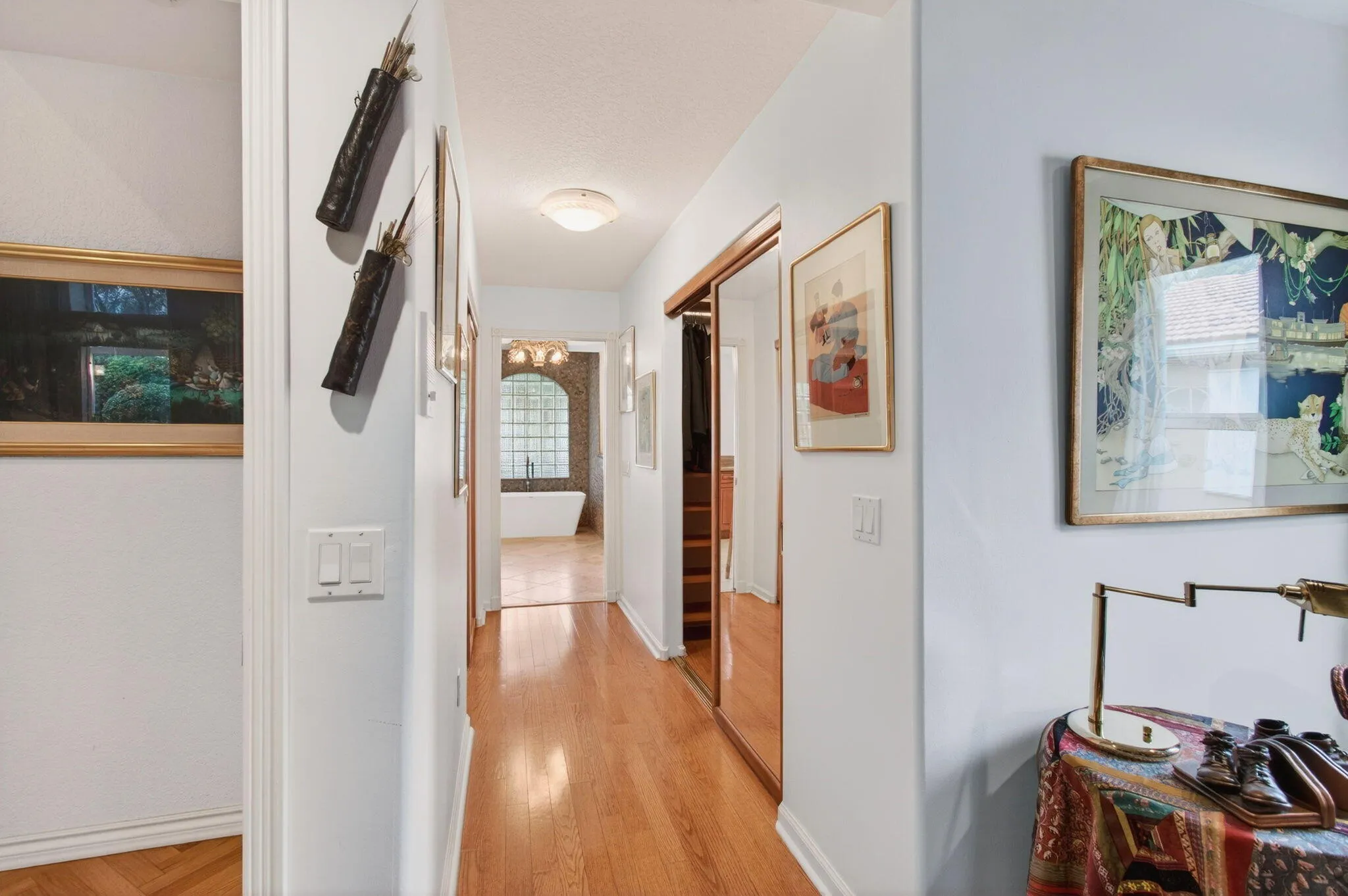 Beyond the bedroom is a corridor with two walk-in closets and an ensuite bath