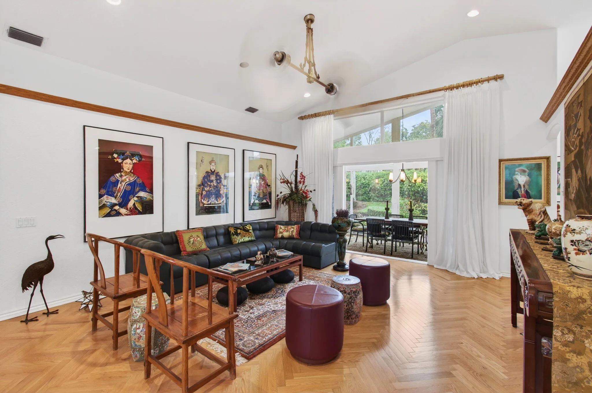 Living Room opens to four-seasons lanai which is used as Garden Dining Room