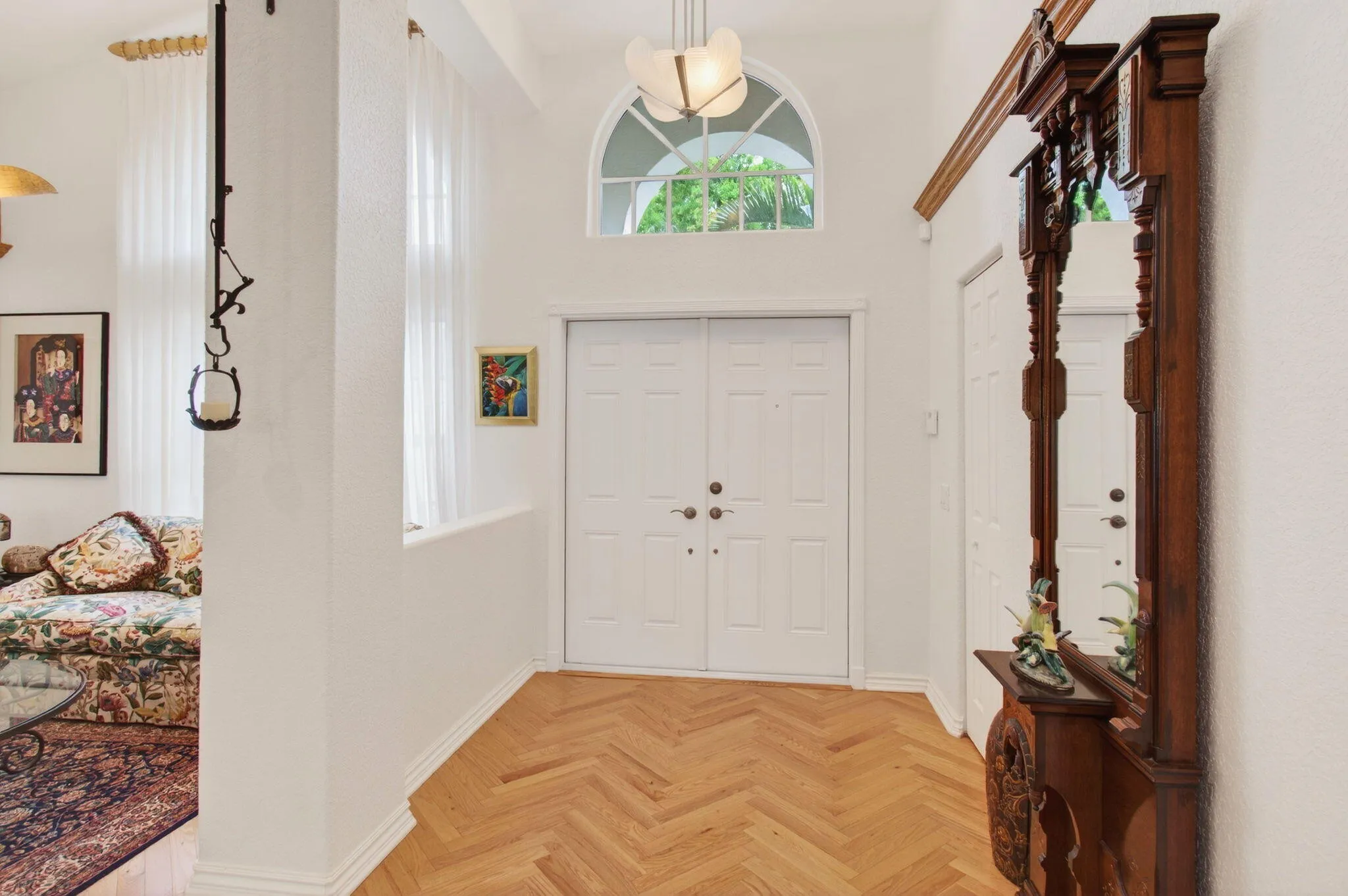 A large Foyer welcomes in guests. The solid wood herringbone flooring runs throughout the home