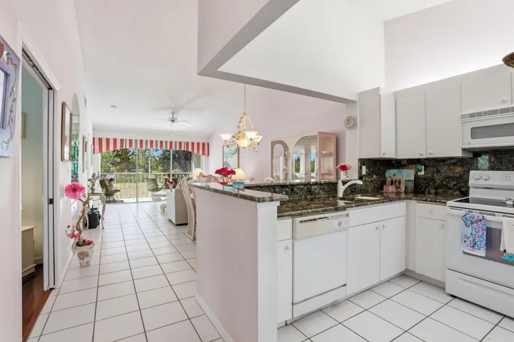 Open Kitchen/living/dining with high ceilings, sunlit spaces and balcony w/ beautiful and private nature views