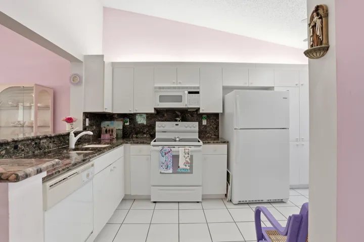 Bright white eat-in kitchen with breakfast bar