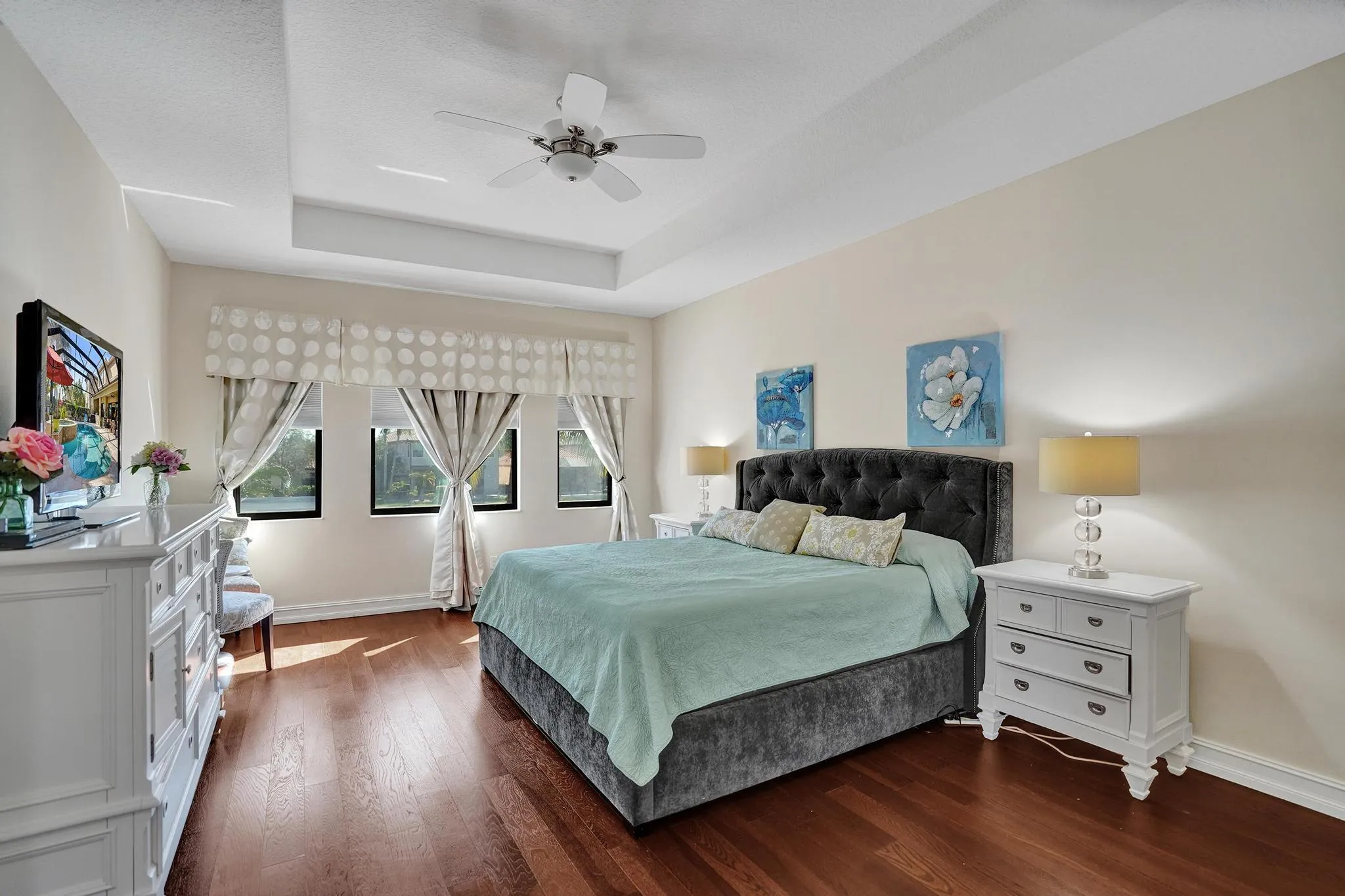 Spacious Suite with cove ceiling wood floors sitting area with view of pool and lake