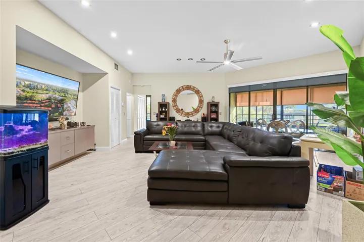 Spacious living room with high soaring ceilings and recessed lighting