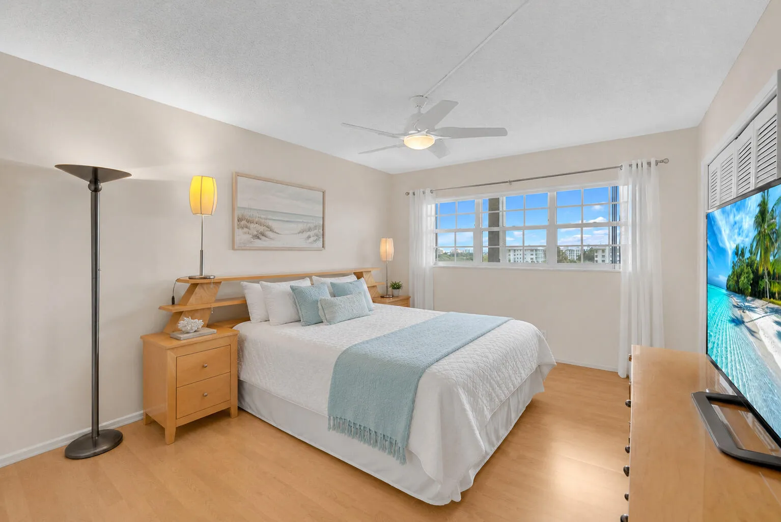 virtually staged primary bedroom w/reach-in and walk-in closet