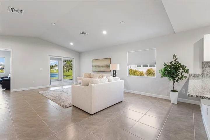 Vaulted ceilings and an open layout enhance the home's spacious feel while filling the interior with natural light.